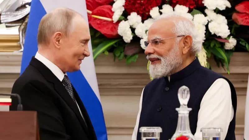 Indian Prime Minister Narendra Modi and Russian President Vladimir Putin ahead of their upcoming meeting in New Delhi, with the Indian and Russian flags in the background.